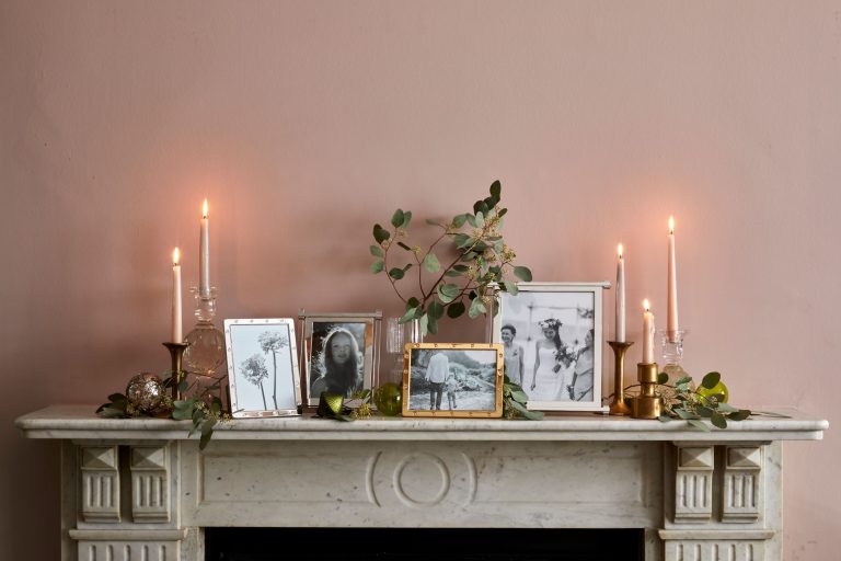 mantlepiece with candles and photo frames