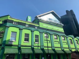 green building with a blue sky background