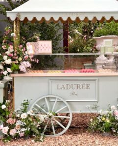 a vintage macaron cart surrounded by flowers