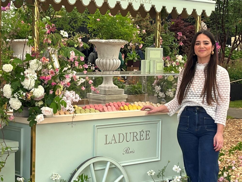 image of girl standing next to a macaron cart