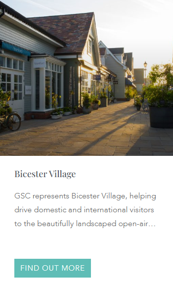 Charming open-air luxury shopping destination at Bicester Village, featuring beautifully landscaped walkways, boutique storefronts