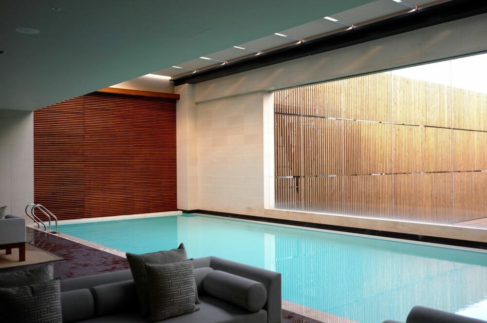 Elegant and upscale wellness retreat featuring luxury indoor pool, natural wood accents